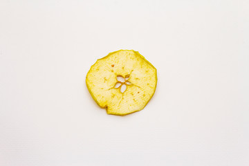 Dried single slice of apple isolated on white background