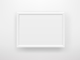 Empty white frame on a white wall. Horizontal composition