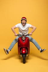 happy delivery man in helmet riding scooter on yellow background © LIGHTFIELD STUDIOS