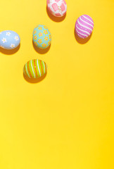 Creative Easter holiday layout eggs colored handmade paint ed isolate.on yellow background.Seasonal flat lay concept.