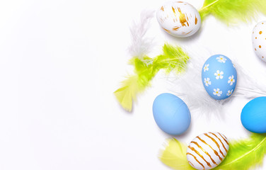 Creative Easter holiday layout eggs colored handmade paint ed with feather on white background.Seasonal flat lay concept.