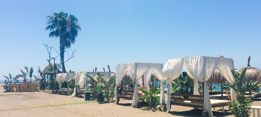 Sunbeds on sandy beach coast in summer, luxury Mediterranean resort as travel and vacation...