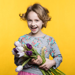 Little girl with a bouquet of tulips