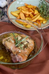 Roasted chicken thighs with olive oil, garlic and rosemary. Served with baked potato wedges