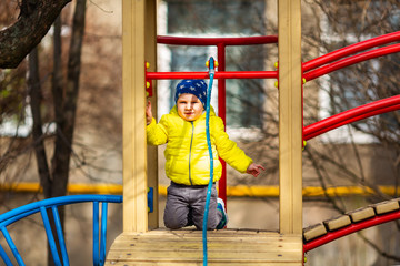 Fototapeta premium Happy little baby boy playing on the playground