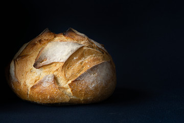 Round Bread Loaf or Boule isolated on the left side. Blue background. Copy space. Concept: healthy live. 