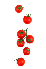 Falling red cherry tomatoes isolated on a white background, clipping path, full depth of field. Flying food.