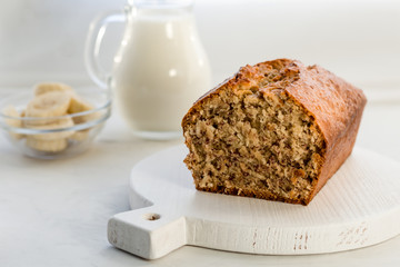 Nar bread with coconut and milk on a light gray background. Homemade delicious pastries. Side view, close- up, copy space.