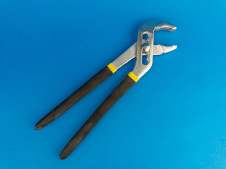 hand wrench lying on a blue background
