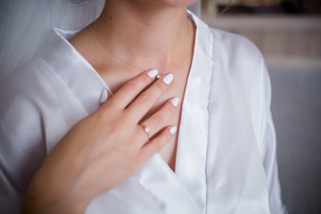 the bride runs her hand along the neckline