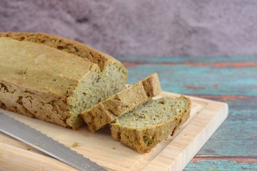 Homemade spinach loaf bread on wooden cutting board