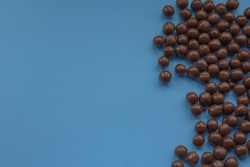 Chocolate balls on a blue background. Top view