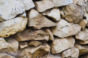 white stones, natural material to use as a background, natural stone texture, quarry, old house wall made of natural stone