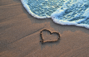 Heart drawn on sand.