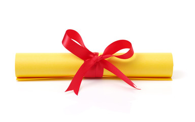 Diploma, close up of paper scroll with red ribbon isolated on white 