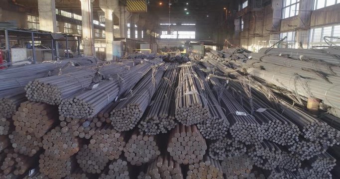 Metal in an indoor warehouse. Metal round billets in a warehouse, span over metal in a warehouse