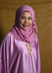 happy and positive senior muslim woman in her 50s wearing Islam hijab head scarf and traditional clothes smiling sweet and cute in Islamic culture and religion concept