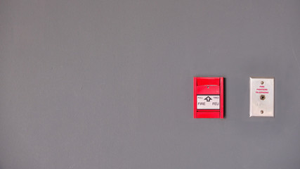 Fire alarm switch on the wall. Switch press button to activate. with outlet for fire fighter telephone, Safety equipment concept.