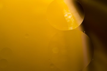 Biodiesel, bubbles biofuel, vegetable oil, yellow and orange emulsion bubbles background.
