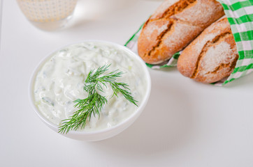 Greek appetizer (salad) - tzatziki. Yogurt, fresh cucumbers and dark (buckwheat) bread (baguette).