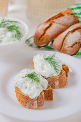Greek appetizer (salad) - tzatziki. Yogurt, fresh cucumbers and dark (buckwheat) bread (baguette).