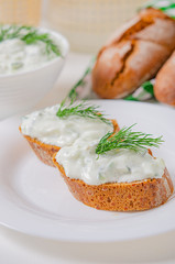 Greek appetizer (salad) - tzatziki. Yogurt, fresh cucumbers and dark (buckwheat) bread (baguette).