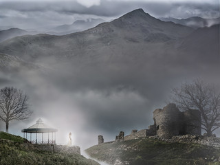 Fantasy landscape with castle and kiosk in the mist with mountains in the background and an...