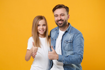 Smiling bearded man in casual clothes have fun with child baby girl. Father, little kid daughter isolated on yellow orange background. Love family day, parenthood childhood concept. Showing thumbs up.