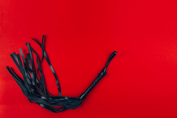 leather braid on a red background, sexy toys
