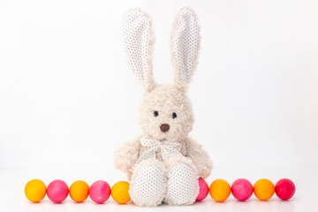 Easter eggs cute bunny with long ears. Happy easter. painted eggs on a light background