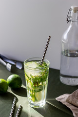 Cocktail mojito with lime, mint and ice. Recipe. Alcohol. Summer drink. Vegetarianism. Health.