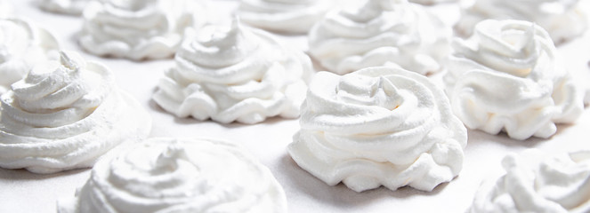 on a white pastel background lies a fresh white handmade marshmallow. copy space