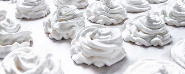 on a white pastel background lies a fresh white handmade marshmallow