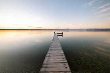 Fototapeta na wymiar Endless Dreamy Landing Stage Ending Into Lake Starnberg