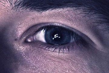 Macro photo of the man's green eye