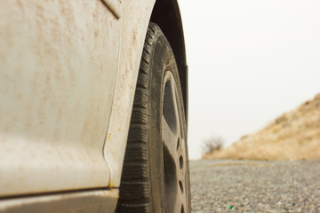 Obraz na płótnie Canvas dirty car tire on street with blurred background