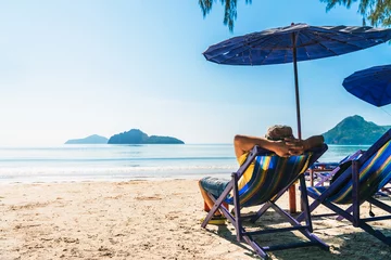 Fototapeten Strand Summer lifestyle Asian man traveler relaxing on beach chair in front of vacation exotic beach, Attraction place leisure tourist travel Hua Hin Thailand holiday trip, Tourism beautiful destination Asia  © day2505