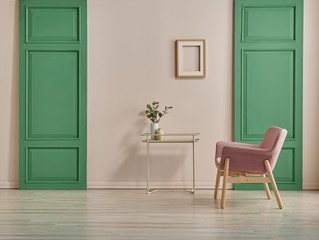 Decorative pink chair and green door style with frame and coffee table. pink wall background.