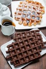 Tasty Belgian dessert, Brussels waffles with chocolade, syrup and white sugar powder