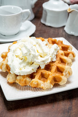 Tasty Belgian dessert, Brussels sugar waffles with  whipped cream