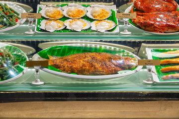Many kinds of delicious food displayed at restaurant showcase