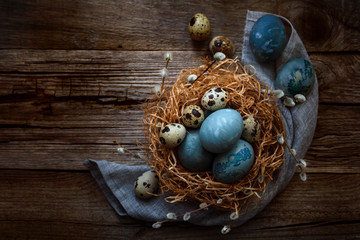 Fototapeta na wymiar Easter nest with eggs on wooden background