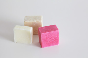 Pieces of hard soap bar or shaving soap or shampoo bar in a zero waste minimalist bathroom
