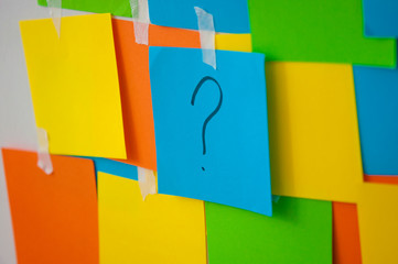 memo sheets on the wall with question mark
