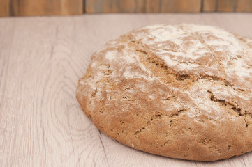Round loaf of freshly backed sourdough bread, with copy space