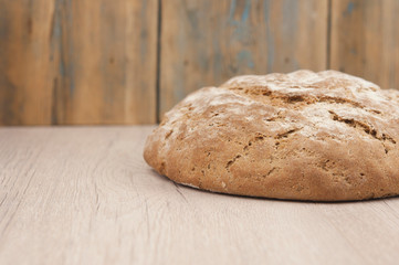Round loaf of freshly backed sourdough bread, with copy space