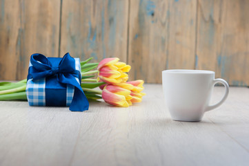Composition with tulips, coffee cup and gift box