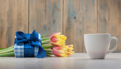 Composition with tulips, coffee cup and gift box