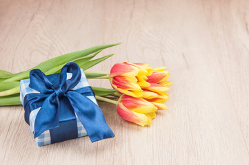 Holidays still life with colorful tulips and gift box