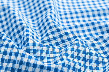 Classic blue and white checkered fabric texture. Crumpled bright colored cotton background....